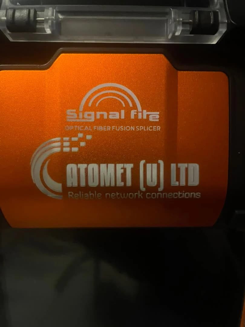 Orange fusion splicer case lid printed with the Atomet (U) Ltd logo and tagline