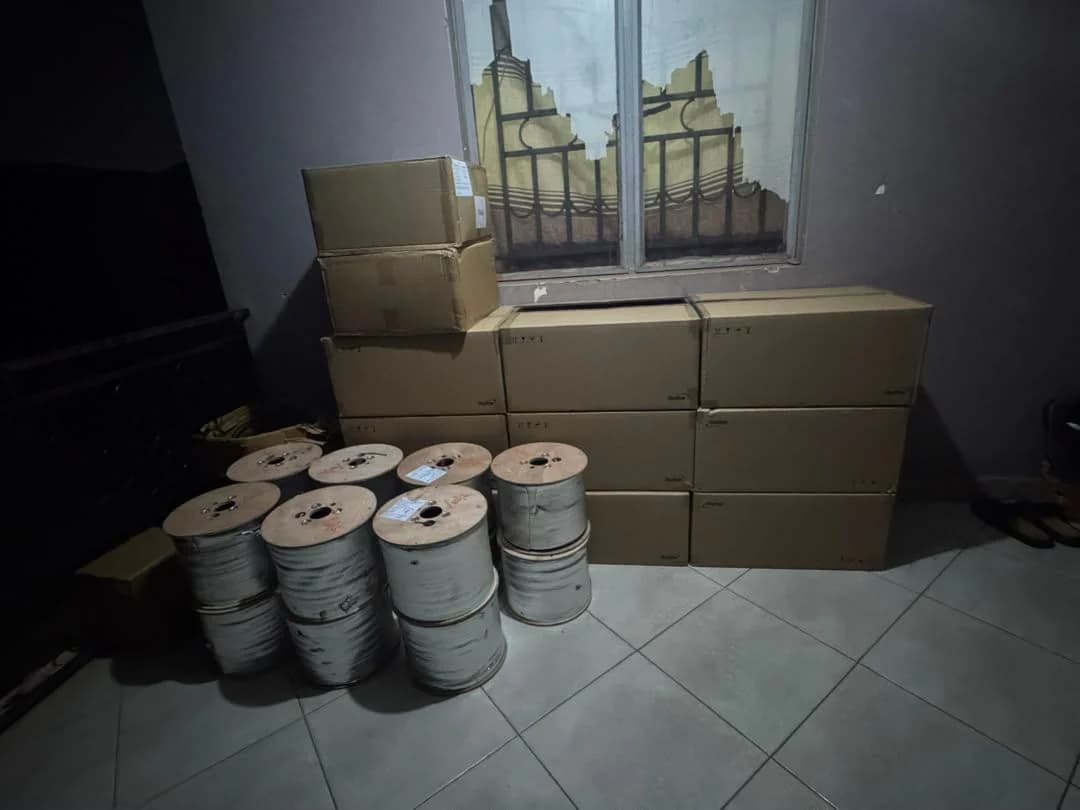 Stack of drop cable reels and boxed materials in a storeroom