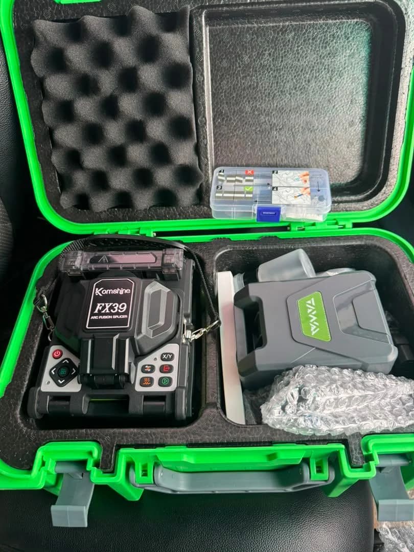 Fusion splicer and fiber cleaver packed in a green protective carry case with foam lining